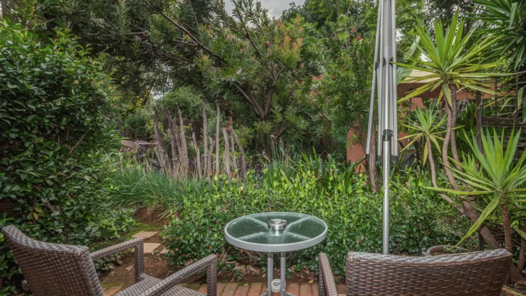 Garden table among tropical plants
