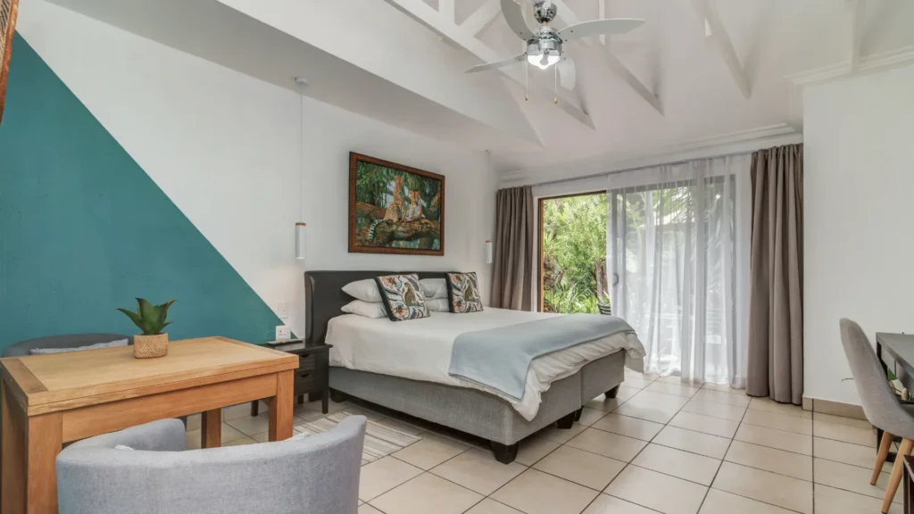 Guest room with a large bed and sliding doors to the garden