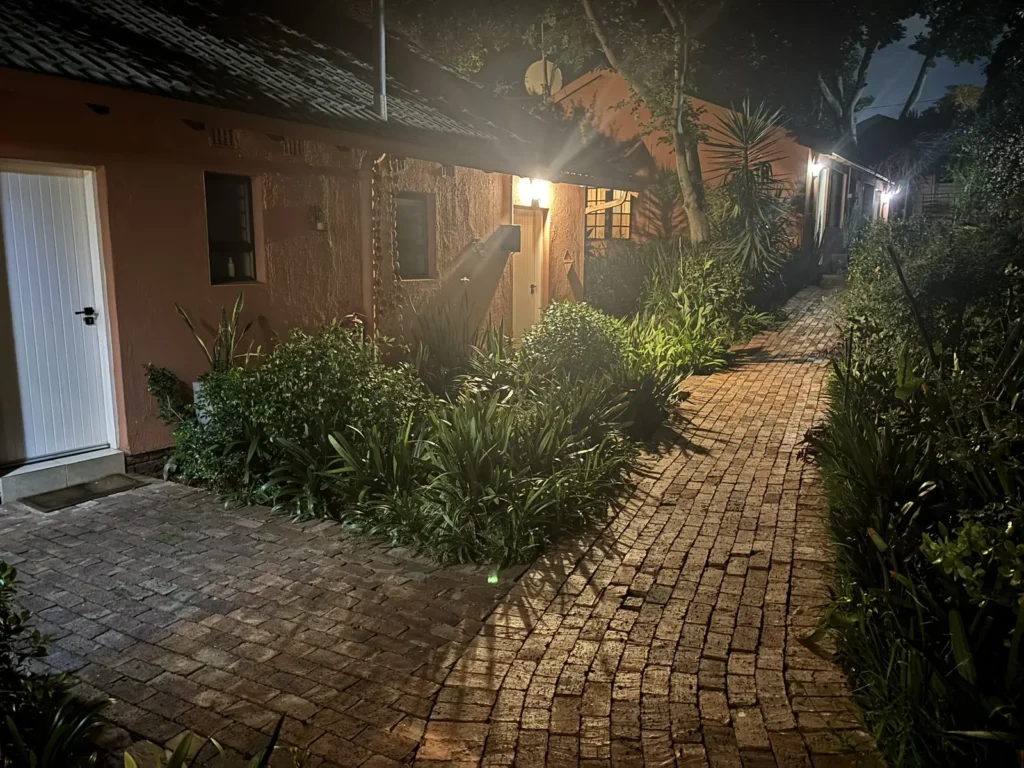 Room entrances and brick path lit up at night